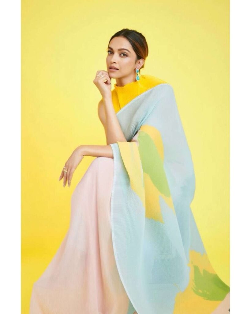 Get Organza Saree blouse ideas from Deepika Padukone wearing a high neck blouse